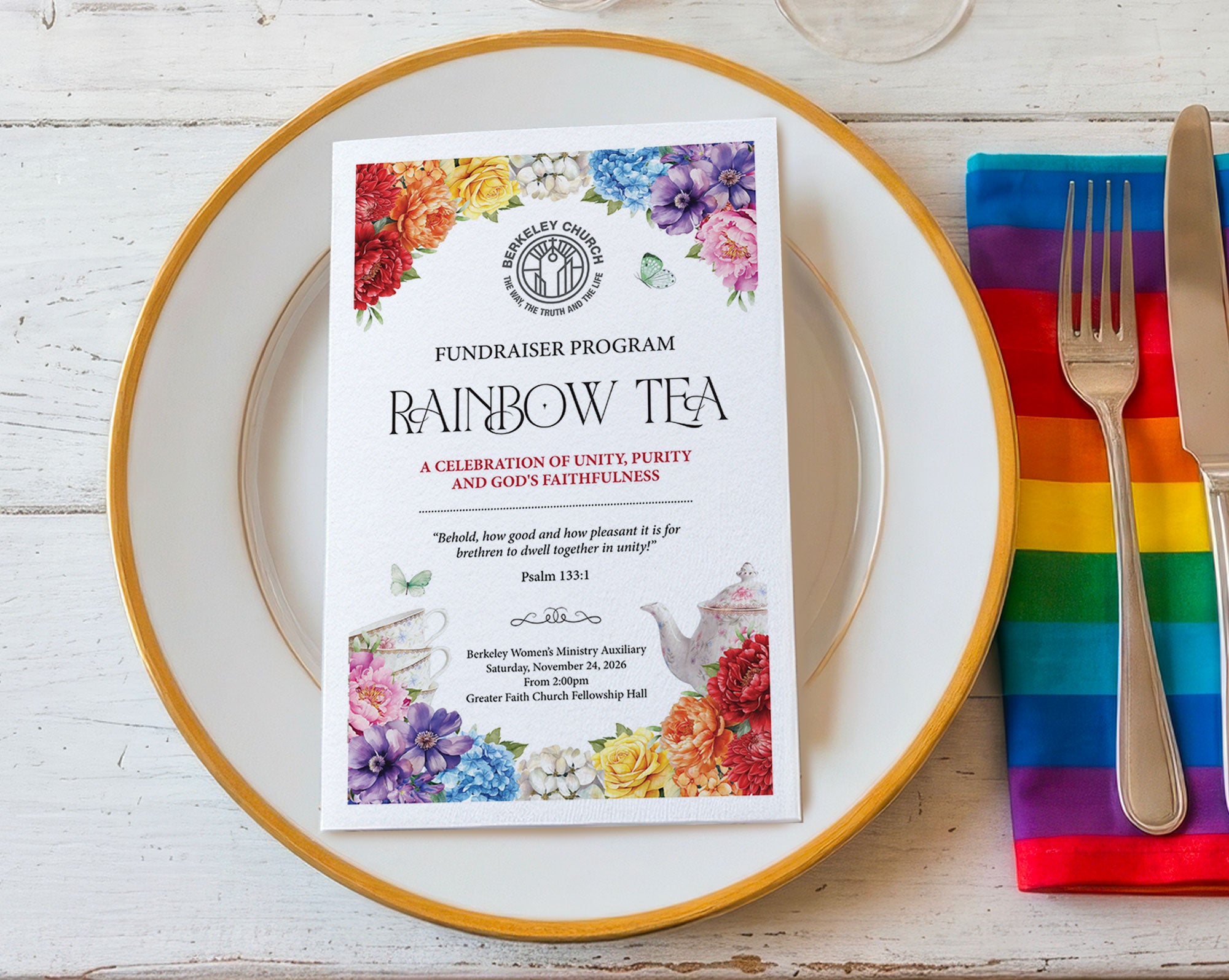 A printed fundraiser program card for 'Rainbow Tea' by the Women's Ministry Auxiliary, styled on a white plate with a gold rim next to a rainbow-striped napkin and silver cutlery on a white wood table.