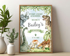 12 x 18 dinosaur party welcome sign in a wooden frame leaning up against a beige wall next to some greenery in white vases