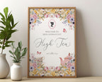 Framed high tea greeting sign with floral design, victorian cameo leaning on a white wall.