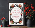 Elegant moody A4 Gothic High Tea Welcome Sign with regency style cameo, red pink flowers and teapot in a black frame leaning against a black wall next to vases of red roses