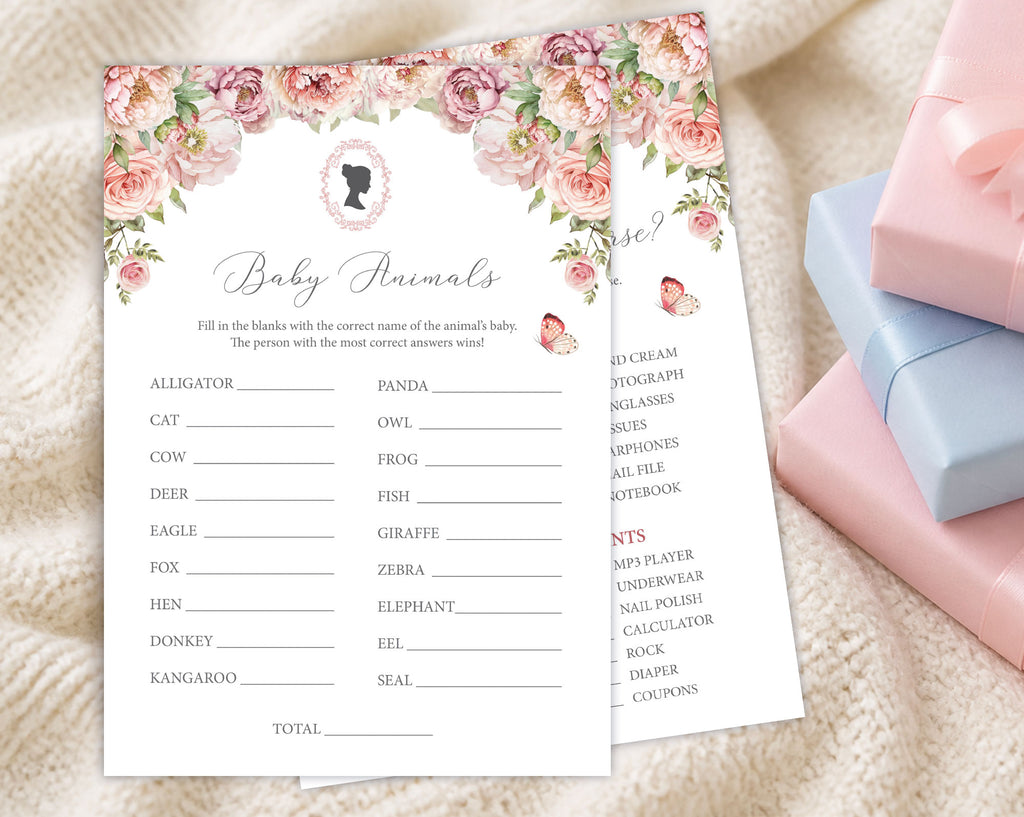 two blush pink baby shower game cards, one titled 'baby shower feud' laying on a cream blanket next to some pink and blue wrapped gifts