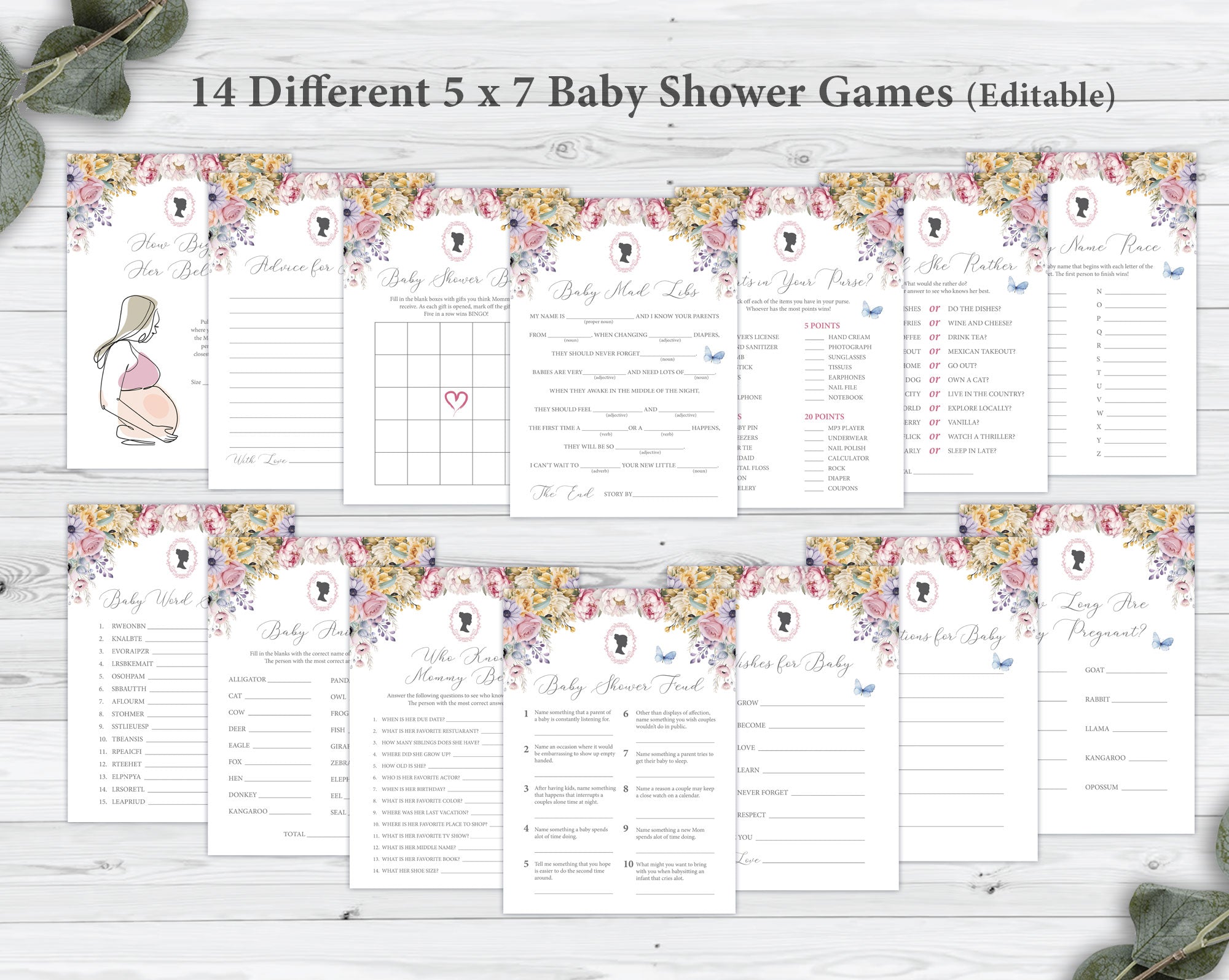14 different baby shower game cards in two rows laying on a grey wooden background next to some eucalyptus leaves