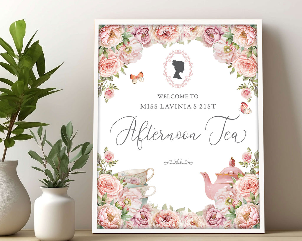 16 x 20 framed afternoon tea welcome sign with blush pink florals and cameo leaning up against a beige wall next to greenery in vases