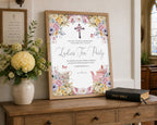 Women's ministries ladies tea party pastel flower welcome sign in a wooden frame on a console table leaning up against a beige wall, with a vase of flowers and a bible next to it