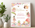 a fairy girls birthday welcome sign with toadstool, frog and girl fairies, in a white frame leaning against a beige wall next to greenery in vases