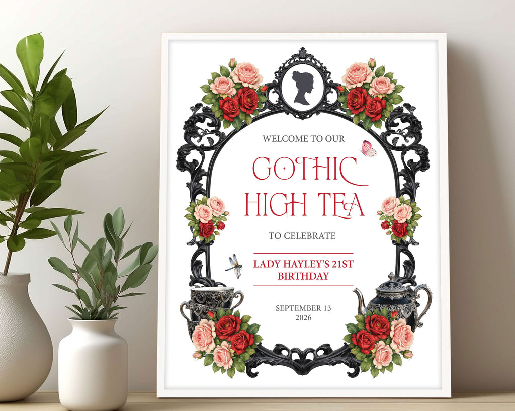 16 x 20 gothic high tea sign with regency cameo, ornate black frame, gothic teapot and cups in a light wooden frame leaning up against a beige wall next to some jars filled with greenery