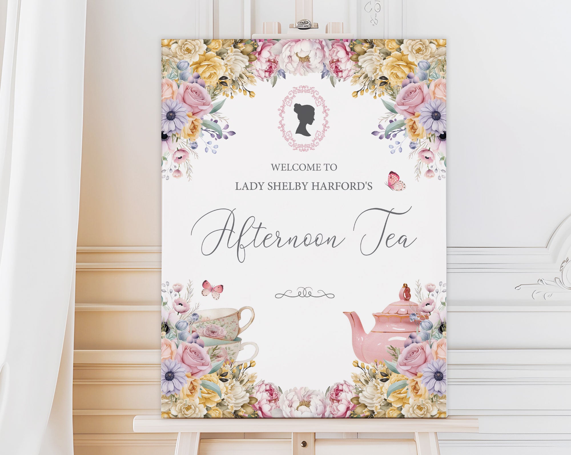 an easel with a Decorative sign for an afternoon tea event with flowers, cameo and teapot illustration.