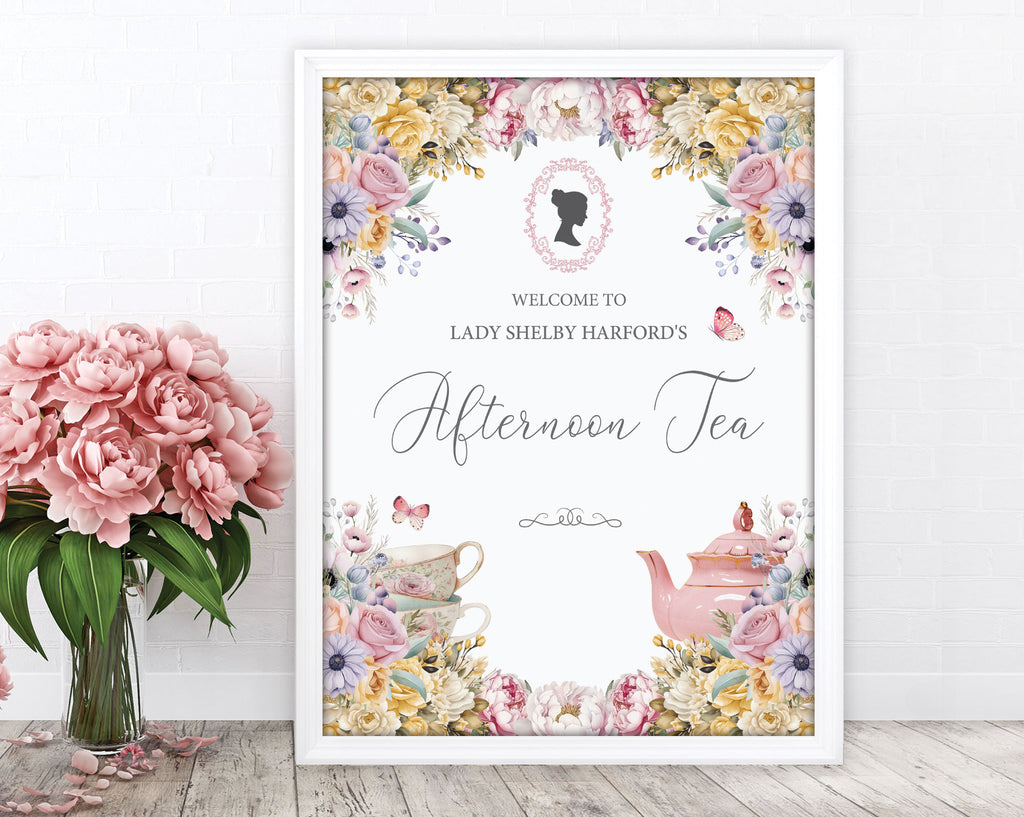 pretty pastel welcome sign for an afternoon tea event with cameo and teapot leaning up against a white wall next to some pink flowers