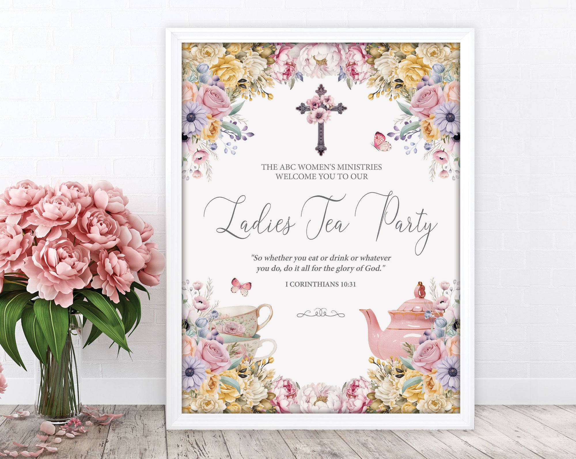 a elegant pastel ladies tea party welcome sign in a white frame leaning up against a white wall next to some pink flowers in a vase