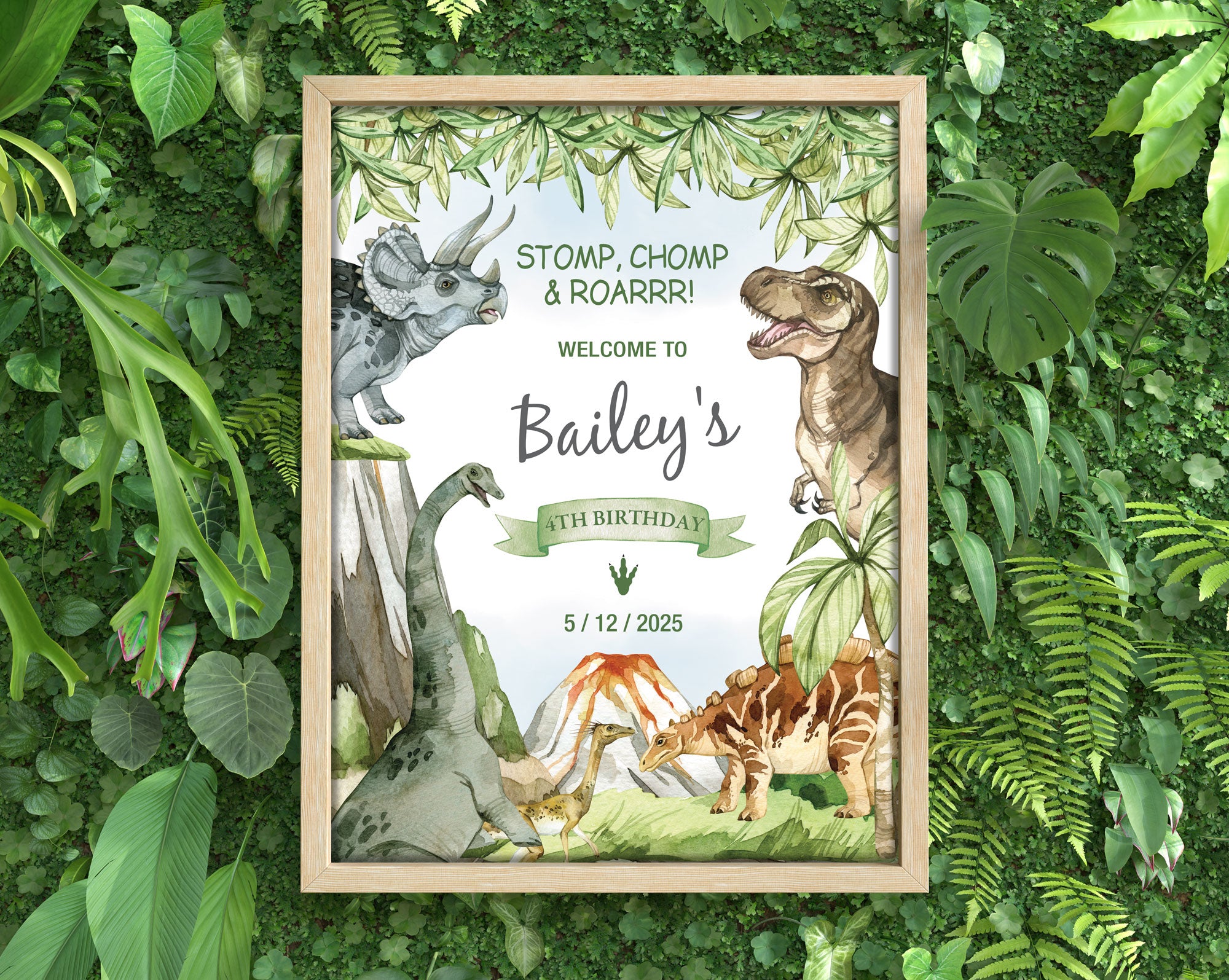 lots of dense greenery with a framed dinosaur party welcome sign in a wooden frame laying on it