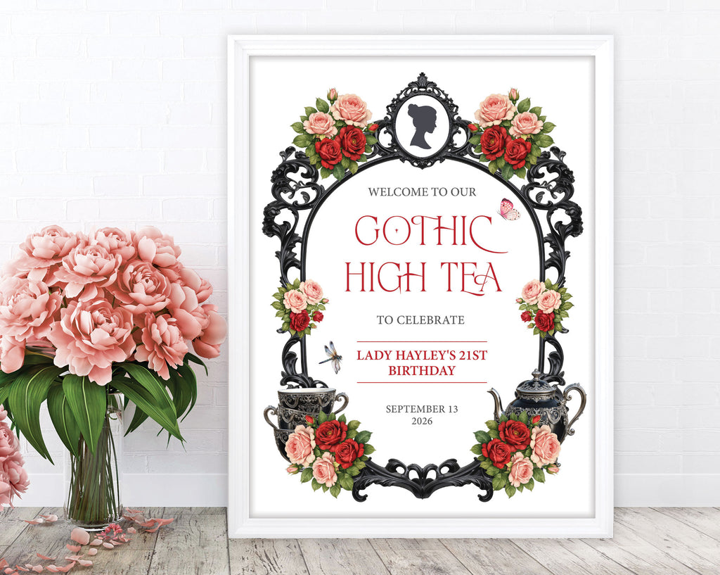 a red black and pink gothic high tea sign in a white frame leaning up against wall next to some blush pink flowers