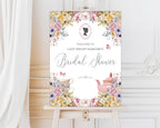 elegant pastel entrance sign for a bridal shower with teapot and cameo on a wooden easel in front of a white panelled wall and curtain