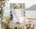 pretty outdoor scene with a 24 x 36 jane austen welcome sign on an easel with a lake in the background, surrounded by pink and white flowers