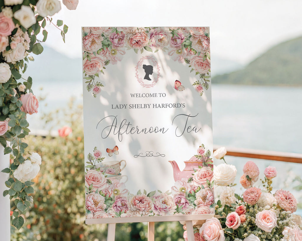 pretty pink 24 x 36 welcome sign for an afternoon tea event with floral and cameo design outside on an easel in front of a seascape with pink and white roses