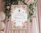 elegant pink flower sign for an afternoon tea event with bridgerton-inspired cameo on an easel surrounded by flowers and balloons.