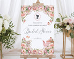 Bridal shower welcome sign with floral design and tea party elements on an easel.