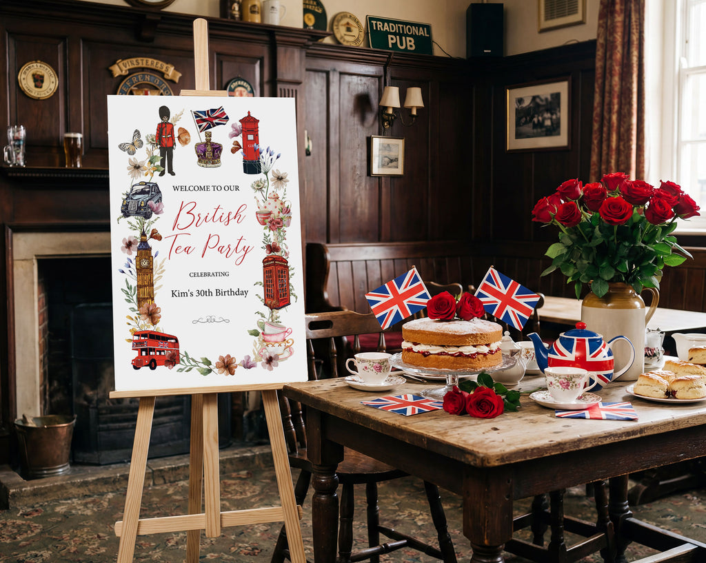 a 24 x 36 british tea party welcome sign next to a wooden table with tea party food, flags and red roses in a pub room