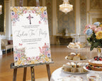 18 x 24 ladies tea party welcome sign with christian flower cross, pastel florals and teapot, on a wooden easel next to a round white tea table set with a tiered stand with sandwiches and cakes, pastel flowers in a vase and a elegant room in the background