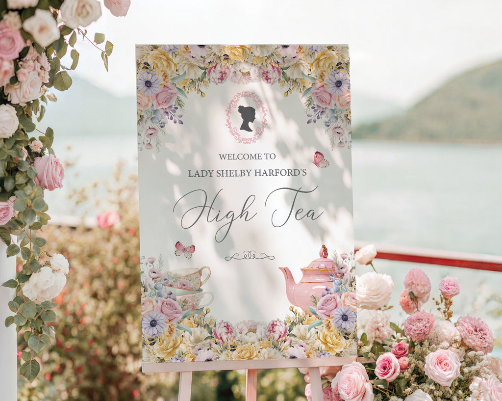 Decorative sign for a high tea event outside with floral design and text, surrounded by flowers and decor.