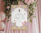 Decorative sign for a high tea event with floral design and pink balloons against a pink curtain.