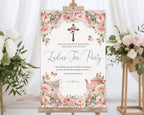 24 x 36 elegant blush pink women's ministries tea welcome sign on an easel next to some flowers on stands with a white curtain in the background