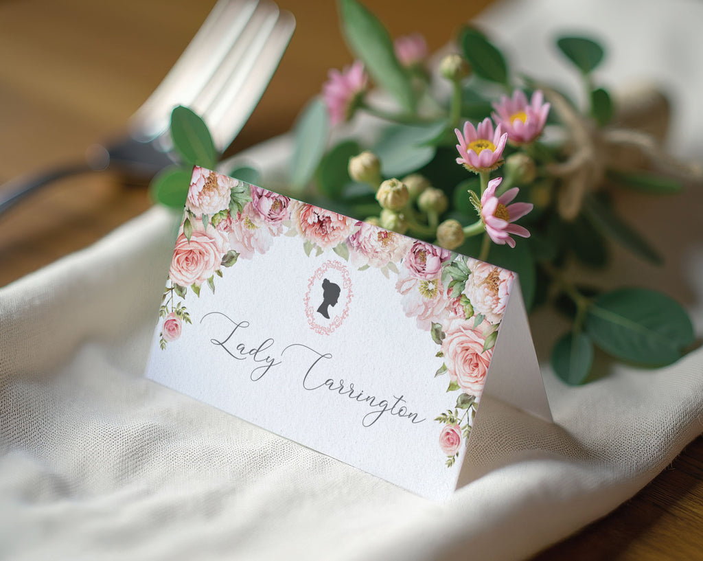 Floral place card with 'Lady Carrington' on a table setting with flowers and cutlery.