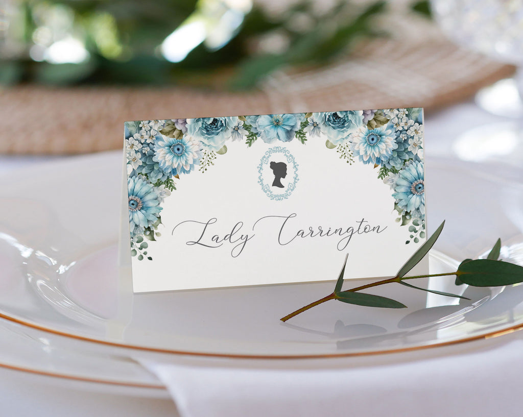 pretty dusty blue flower place name tent card on a glass plate