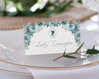 pretty dusty blue flower place name tent card on a glass plate