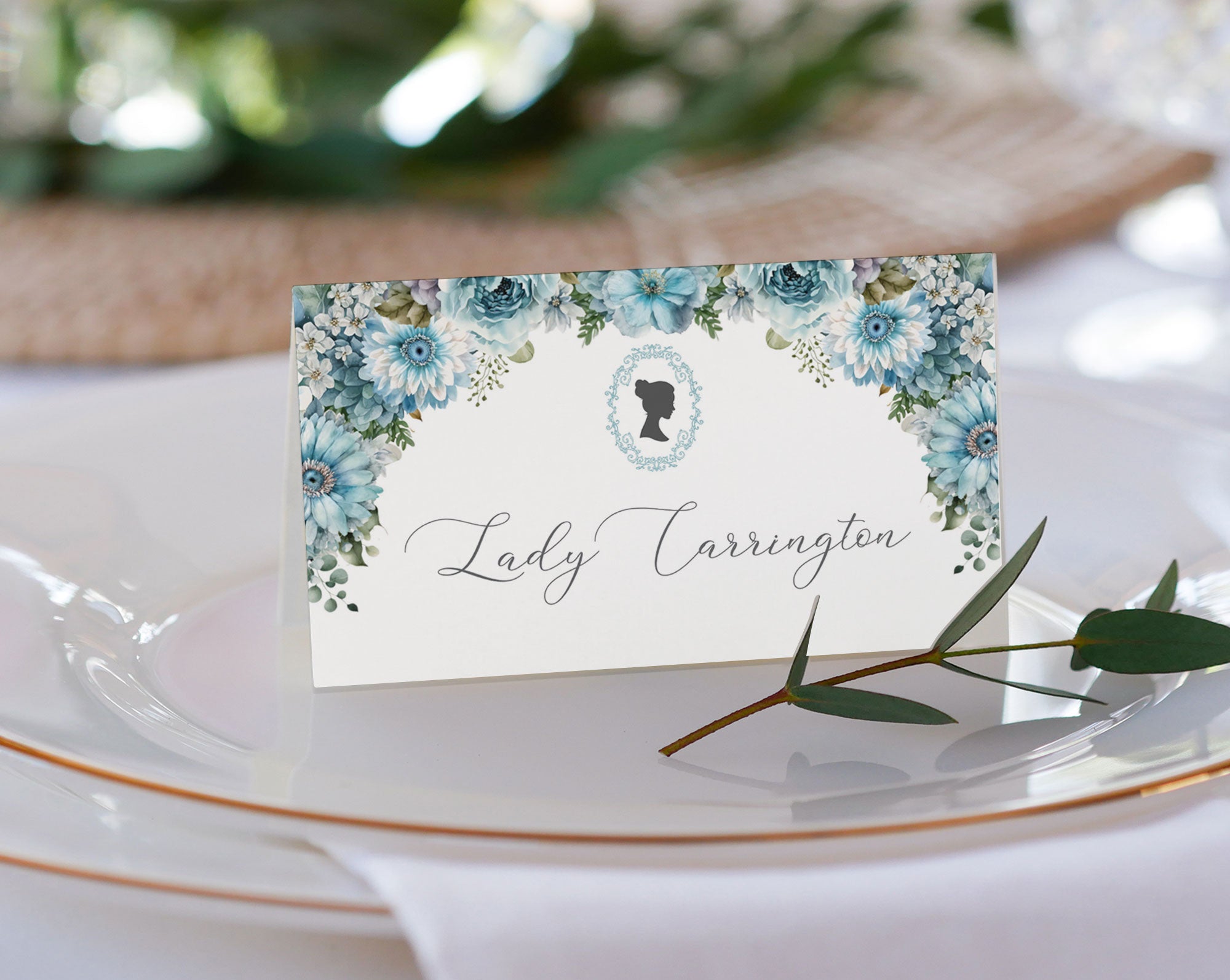 pretty dusty blue flower place name tent card on a glass plate
