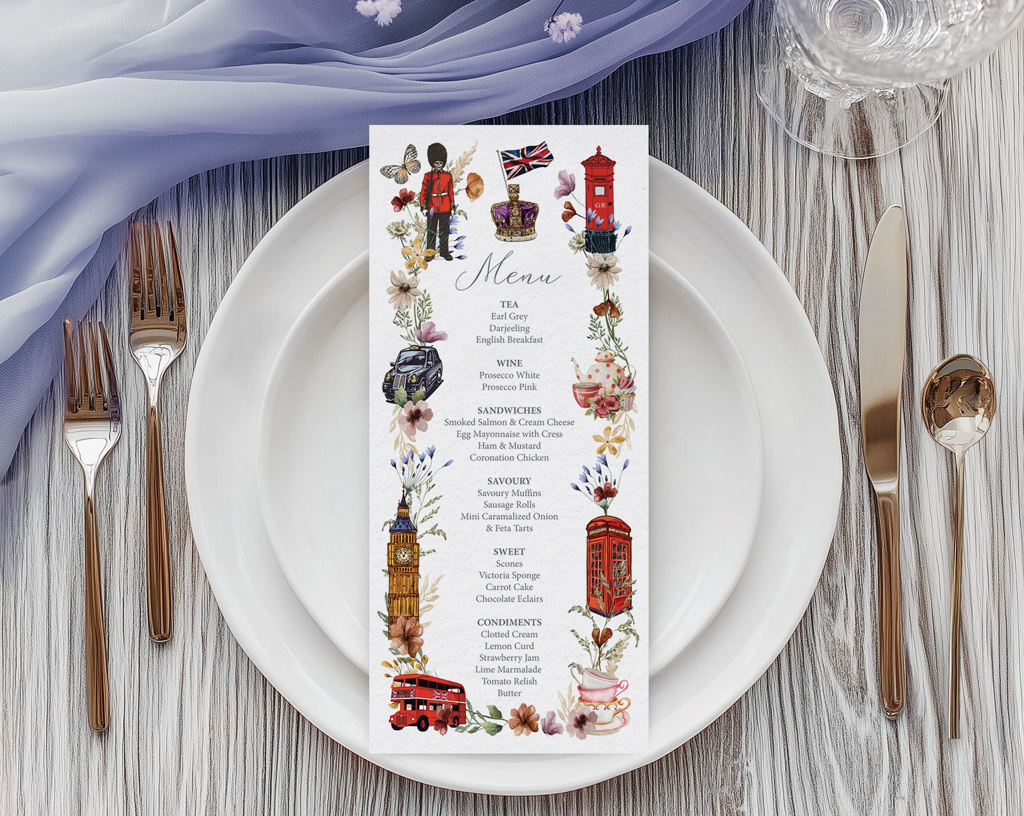 a pretty british icon menu with black cab, big ben, crown, telephone box and double decker bus graphics, laying on a white plate, with cutlery and a blue gauzy cloth above it