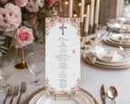 blush pink flower church event menu with christian cross in a gold stand on a white table set for a dinner