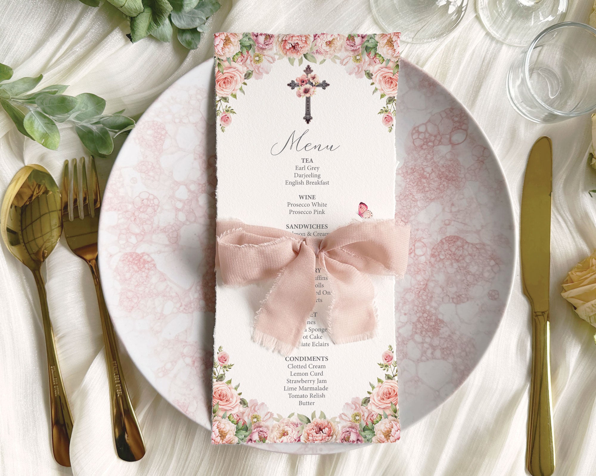 blush pink flower church menu with cross and butterfly lying on a pink pattern plate wrapped in a pink bow