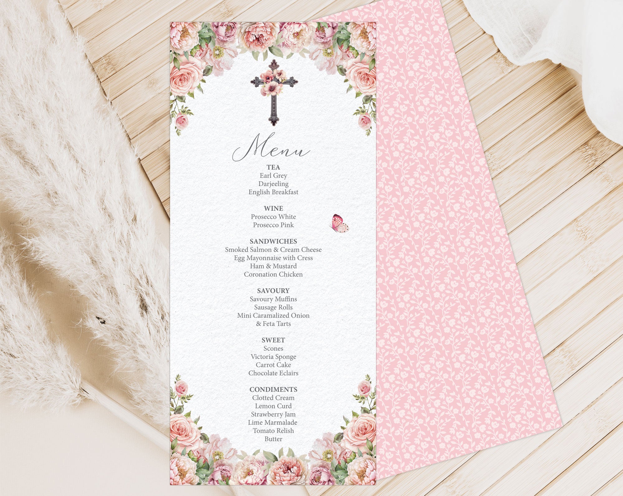 church afternoon tea menu laying on a wooden surface showing the pink pattern back
