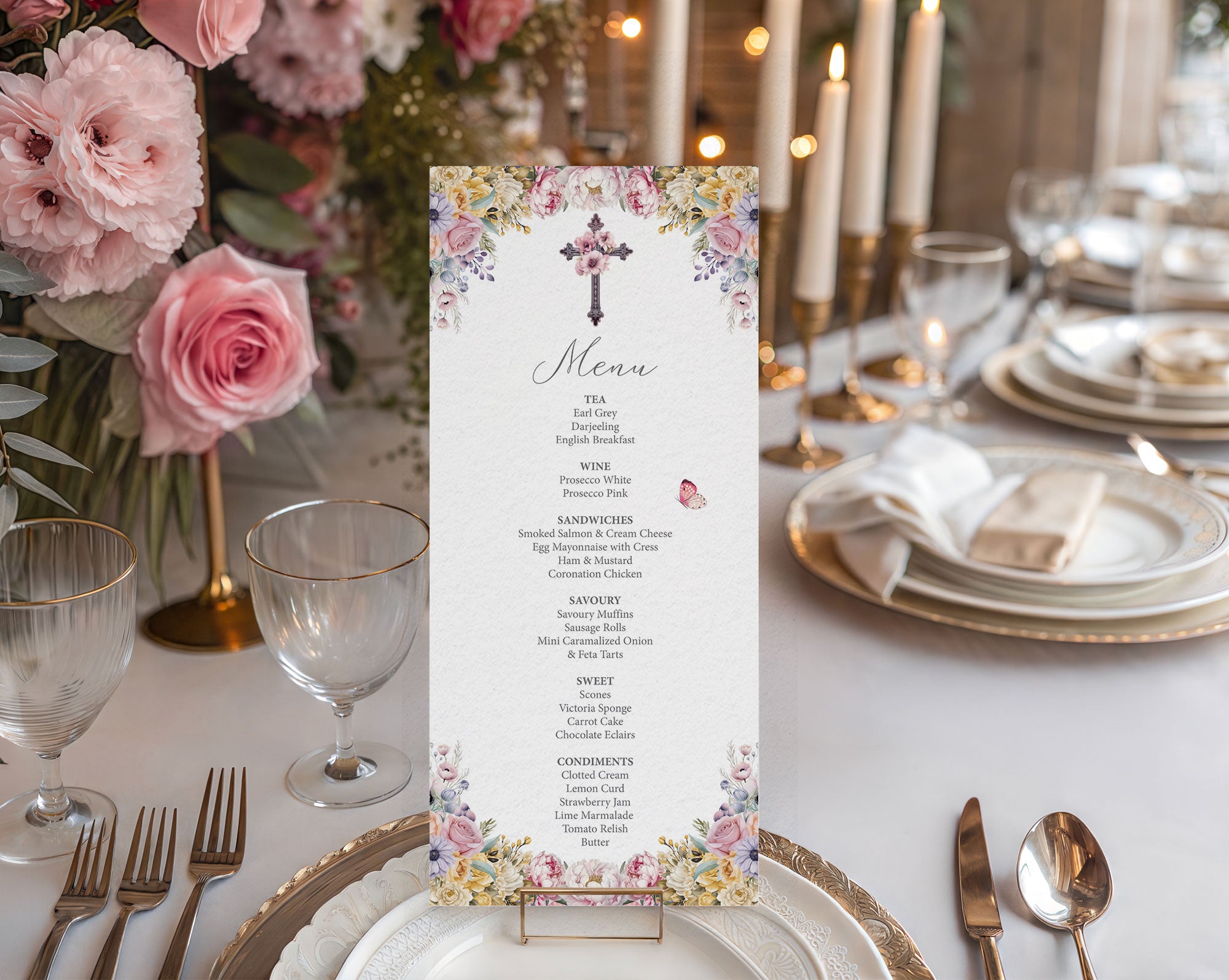 Decorative church event tea menu card in a gold stand on a table set for a meal with flowers and candles.