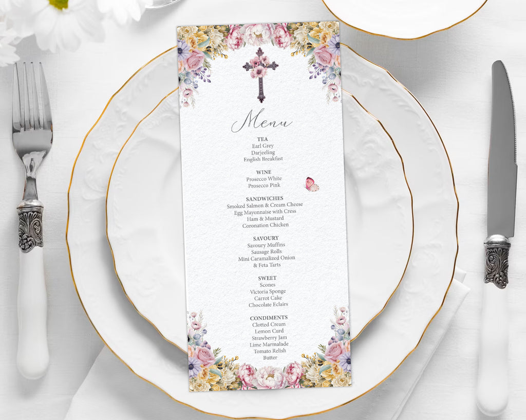 church ladies Menu card with floral design and christian cross on a white plate with gold rim and silverware.