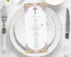 church ladies Menu card with floral design and christian cross on a white plate with gold rim and silverware.