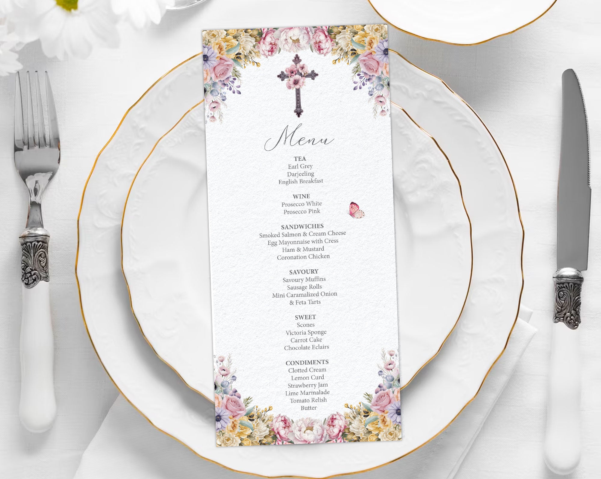 church ladies Menu card with floral design and christian cross on a white plate with gold rim and silverware.