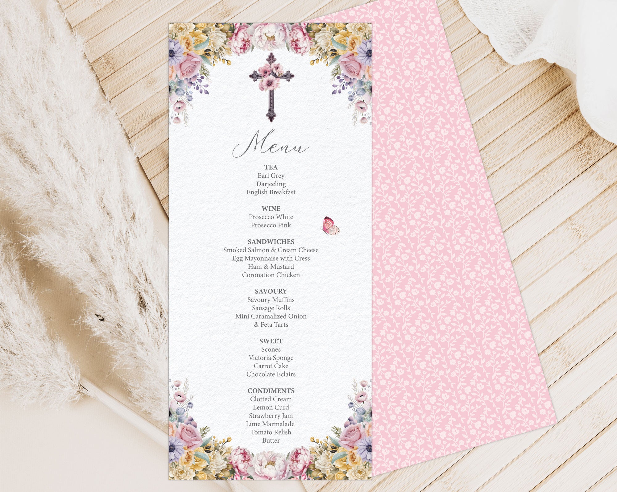 Pastel religious Menu card with floral and cross design on a wooden surface showing the pink pattern back
