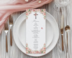 blush pink flower church menu with cross laying on a white plate with gold cutlery