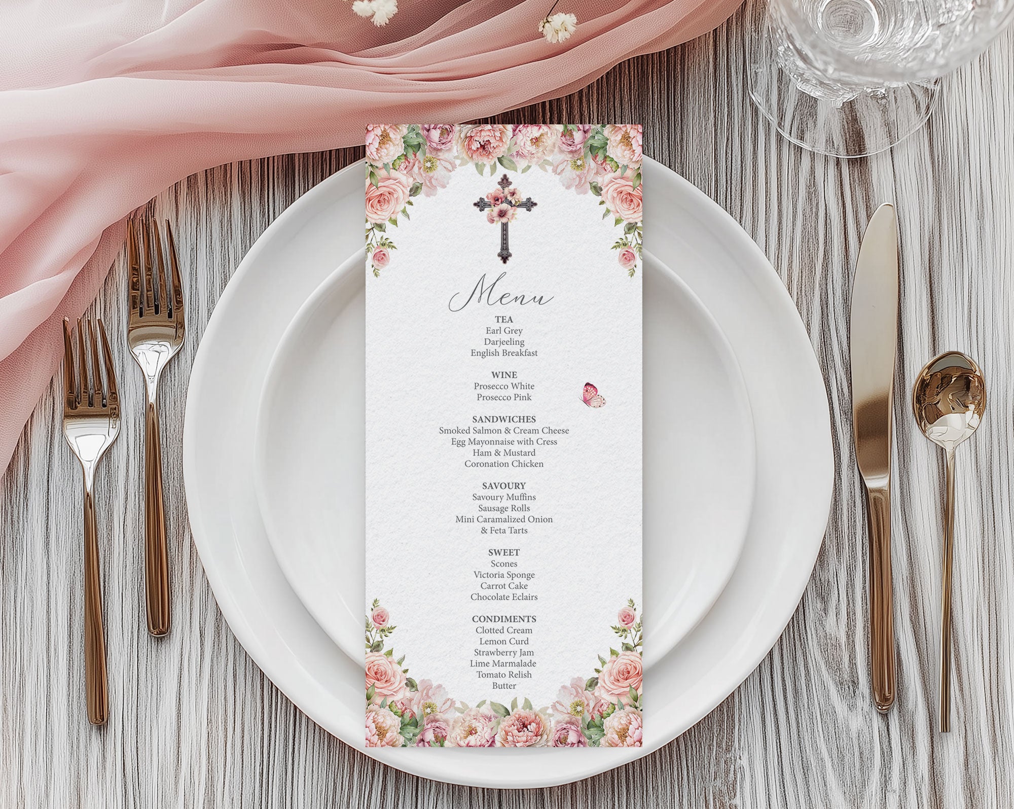 blush pink flower church menu with cross laying on a white plate with gold cutlery