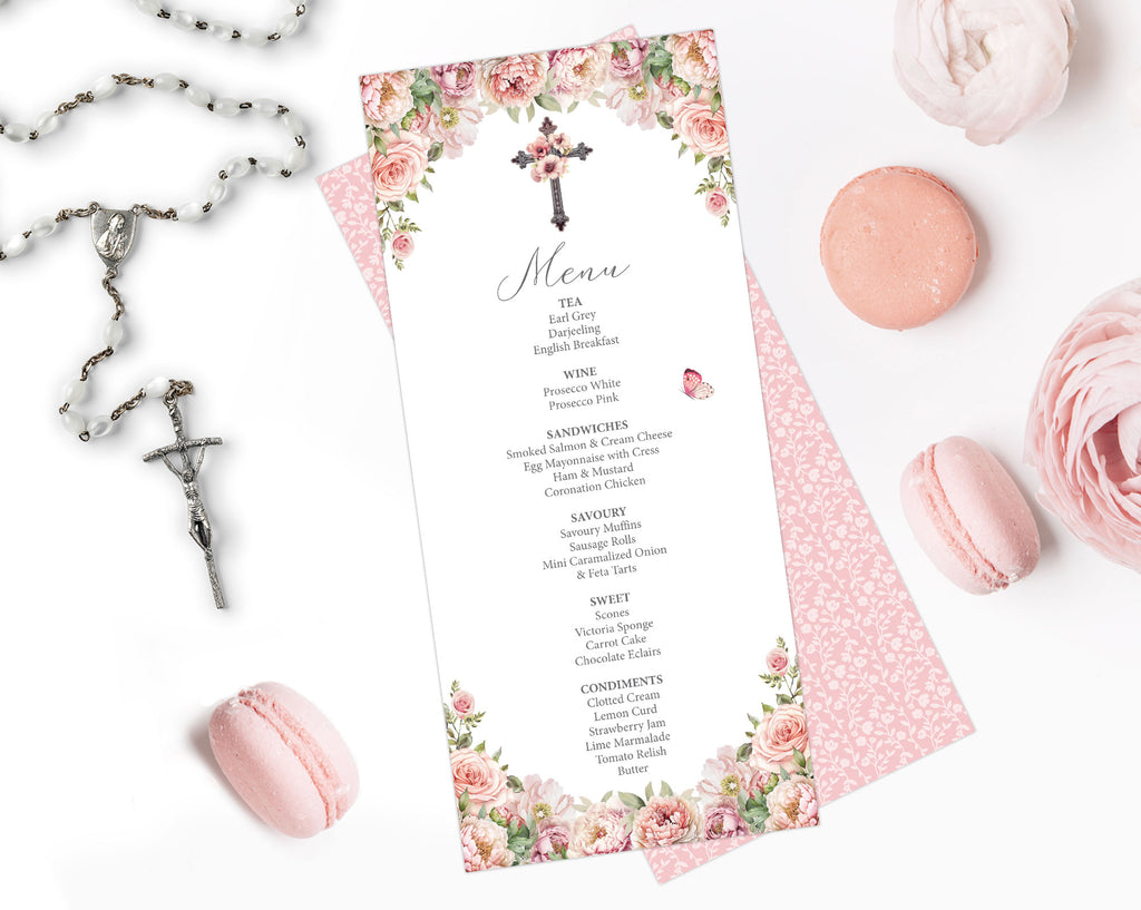 pink flower menu for a church event with cross and pretty pattern back lying on a white background next to a rosary and macarons