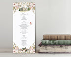 Jane austen menu card with floral design and mansion illustration leaning on a grey background, next to stacked books.