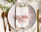 Decorative Jane Austen menu card with floral design, mansion and book graphics, wrapped with a ribbon on a table setting with plates, cutlery, and glasses.