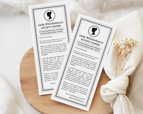 two 'Lady Whistledown's Society Bachelorette Party Announcement Papers' on a wooden surface with a white fabric background.