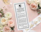 a hen party regency society announcement note, sitting on a pretty blush pink background with light pink and cream flowers and a bride-to-be white sash