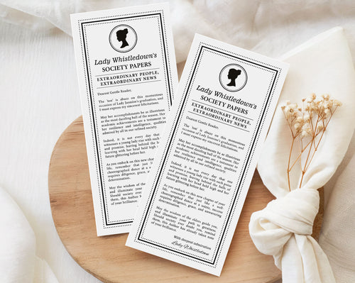 two 'Lady Whistledown's Society graduation Announcement Papers' on a wooden surface with a white fabric background.