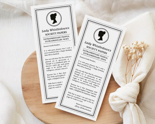pretty black and white regency style society notice for a Birthday sitting on wooden tray with white muslin cloth and dried flowers