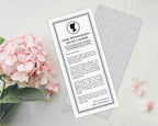 pink hydrangea next to a printed 'Lady Whistledown's Society Papers' with regency cameo on a white surface.