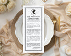 elegant black and white lady whistledown society paper bridal shower announcement on a table setting with white roses and gold cutlery.