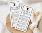 two 'Lady Whistledown's Society Bridal Shower Announcement Papers' on a wooden surface with a white fabric background.
